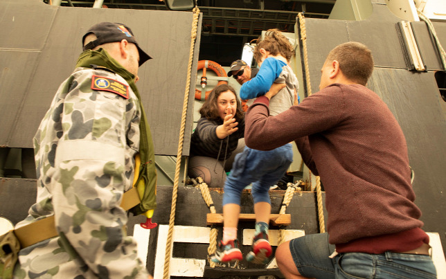 Lángokban áll az ausztrál város, haditengerészek mentik a lakosokat